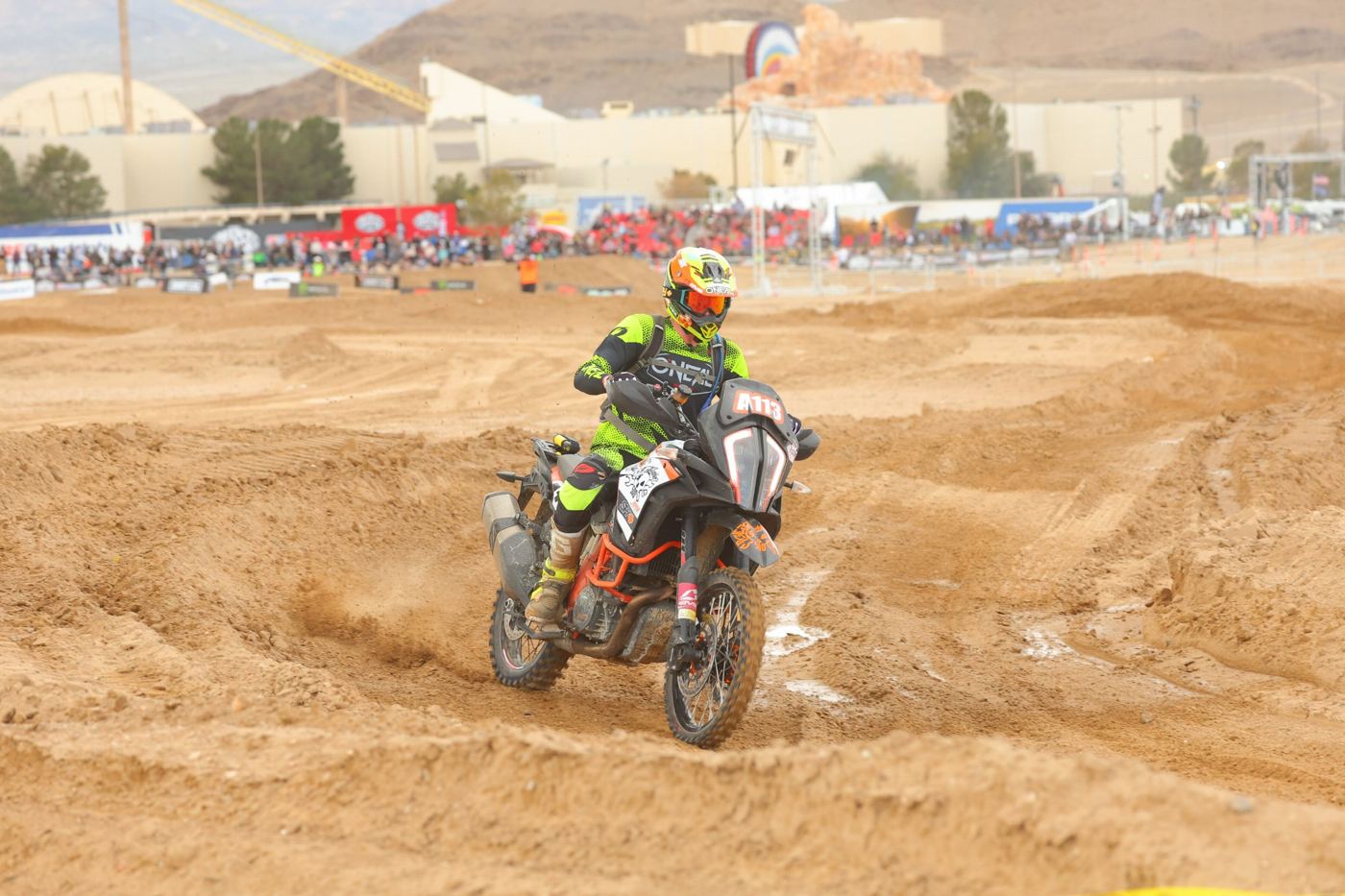The KTM, number A113, cornering through a sand berm at the Mint 400