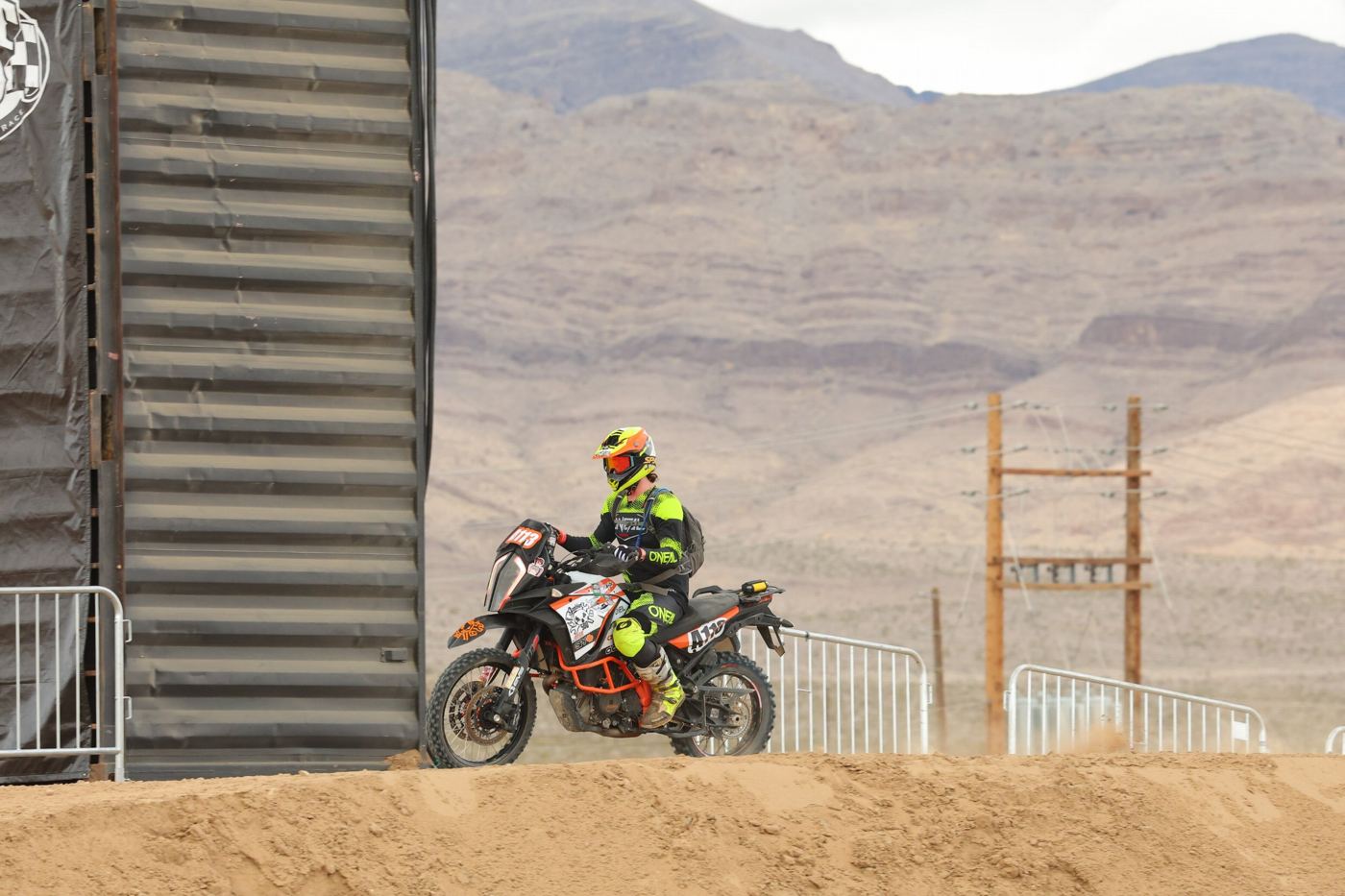 Riding along the course in front of desert mountains